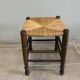 Wooden stool with a straw seat