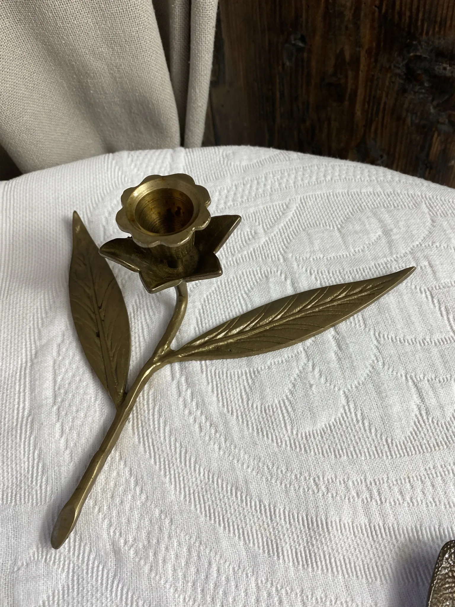 Flower candlestick and removable ashtrays in solid brass.