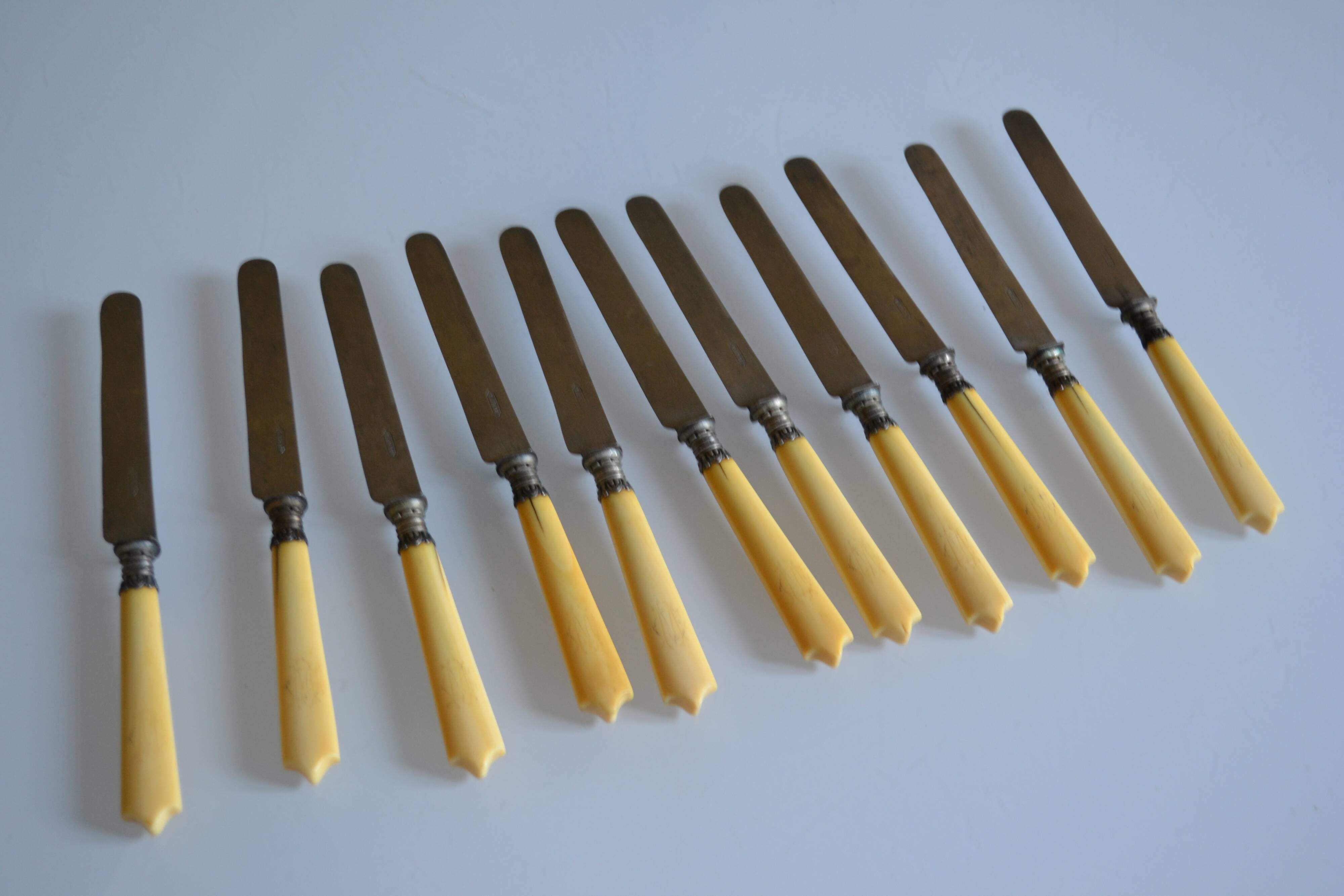 11 antique dessert knives from the 19th century with ivory-colored handles and a monogram