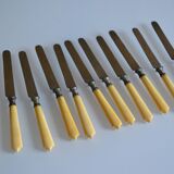 11 antique dessert knives from the 19th century with ivory-colored handles and a monogram