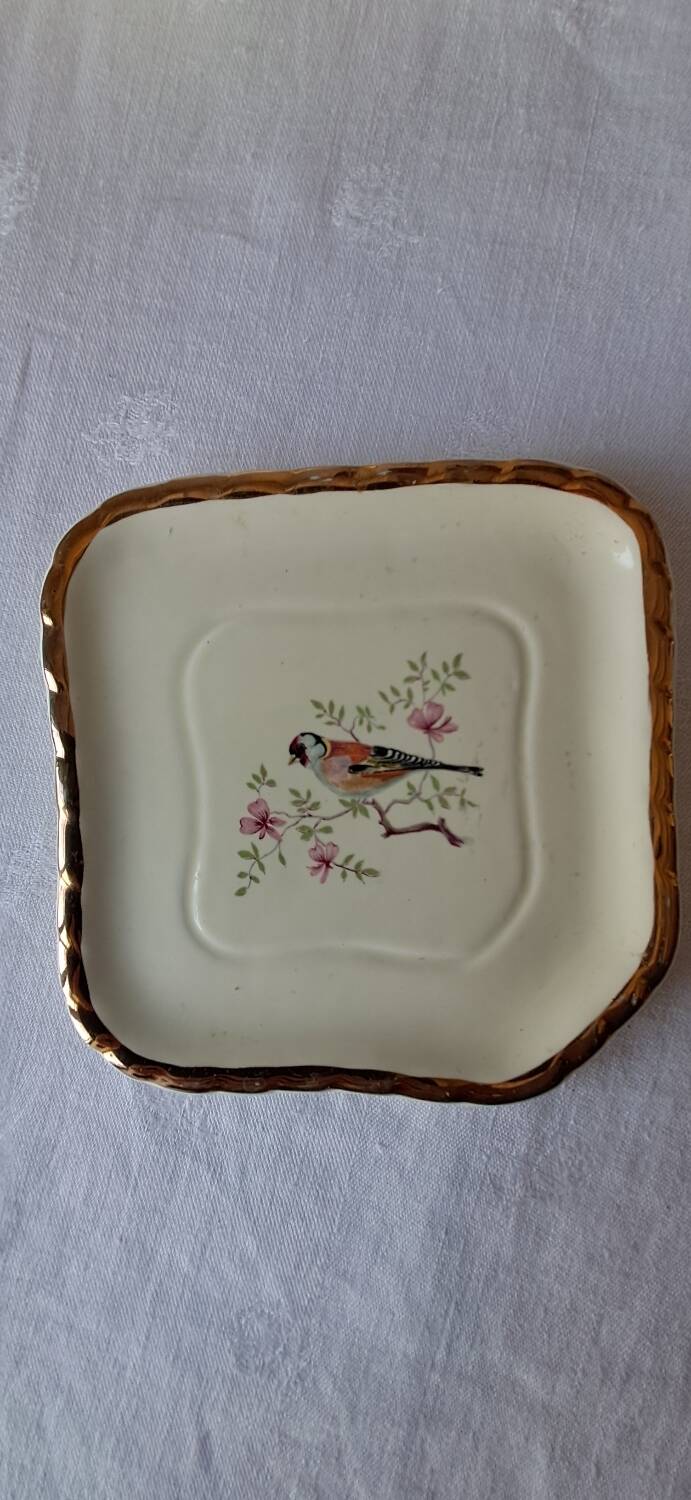 Trivet and bottle holder Salin, 1950s. Bird on branch.