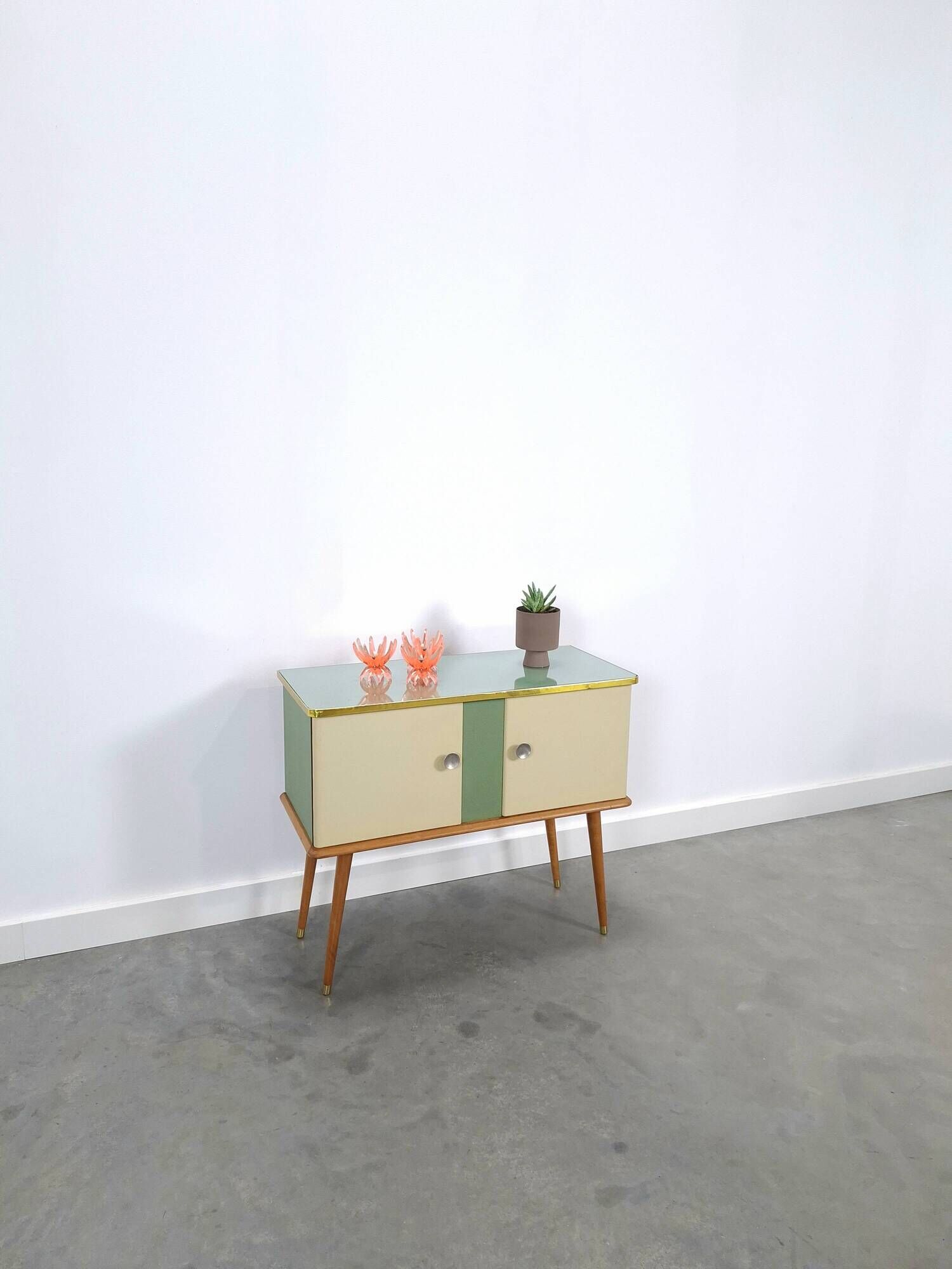 Vintage green DDR cabinet, model Libelle with glass top, slanted legs.
