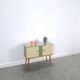Vintage green DDR cabinet, model Libelle with glass top, slanted legs.