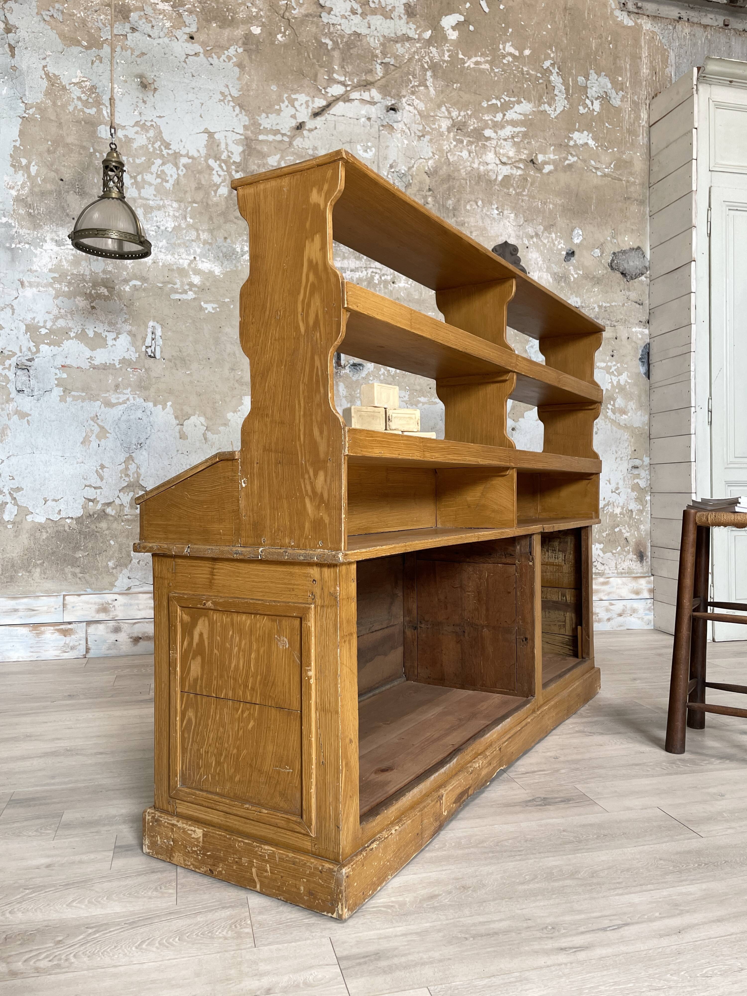 Wooden hardware cabinet painted with wood effect, circa 1940.
