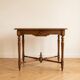 Antique walnut desk with a drawer and turned legs.
