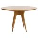 Round dining table in Wood Wood with brass details.
