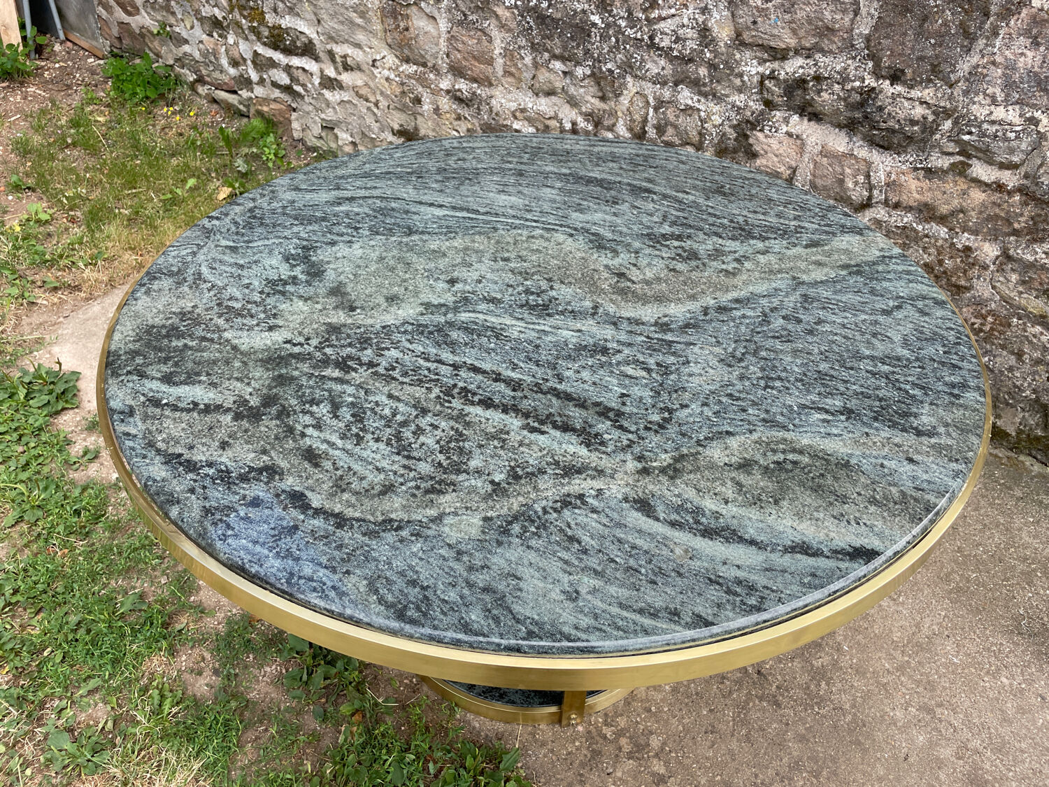 Round dining table with green marble and solid brass.