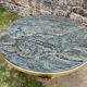 Round dining table with green marble and solid brass.