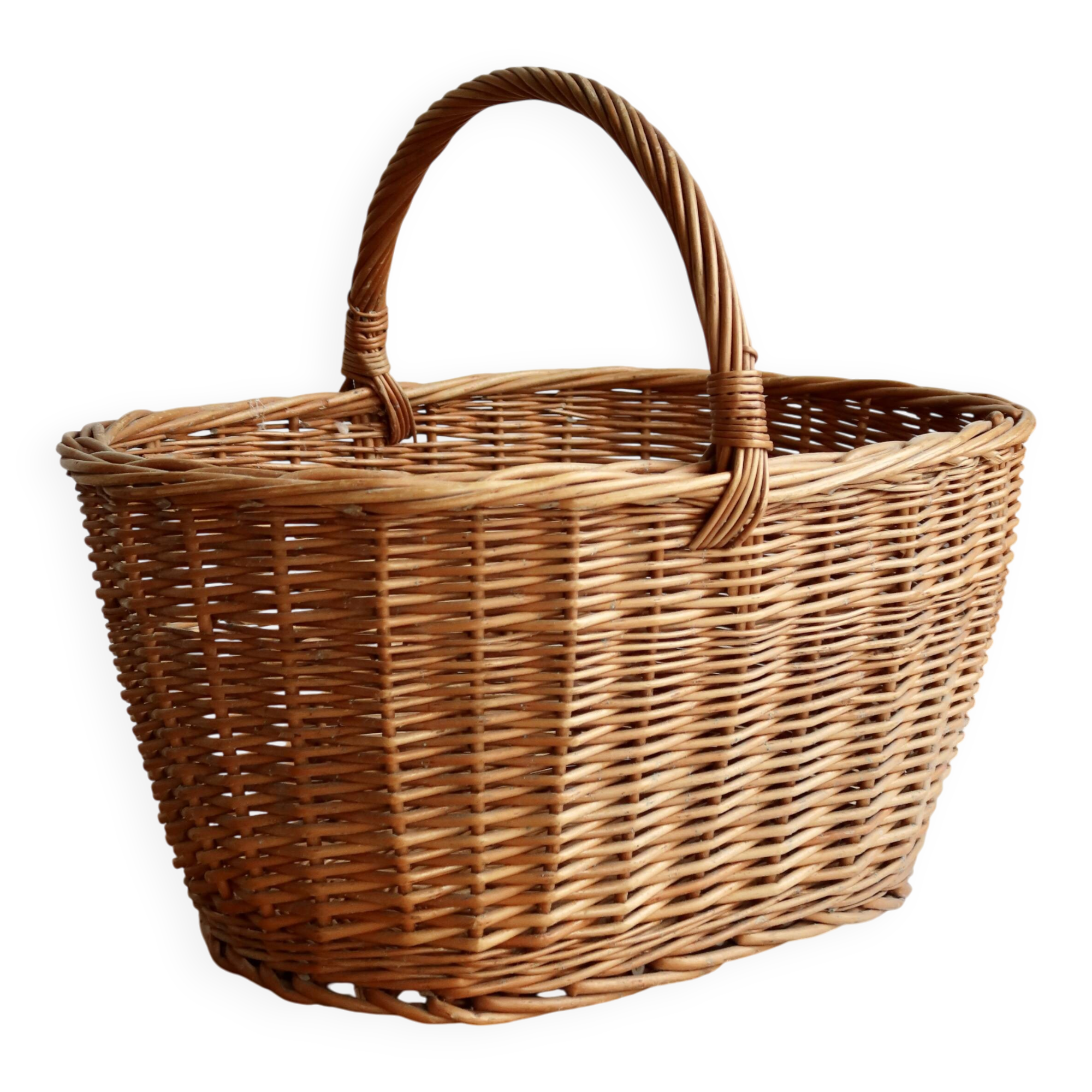 Large vintage woven wicker basket with a central handle.