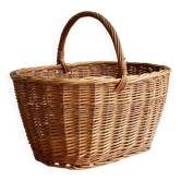 Large vintage woven wicker basket with a central handle.