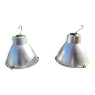 Pair of industrial pendant lights in aluminium and glass.