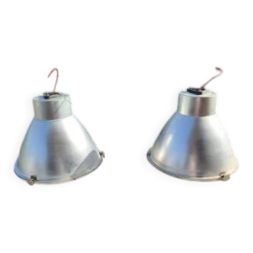 Pair of industrial pendant lights in aluminium and glass.