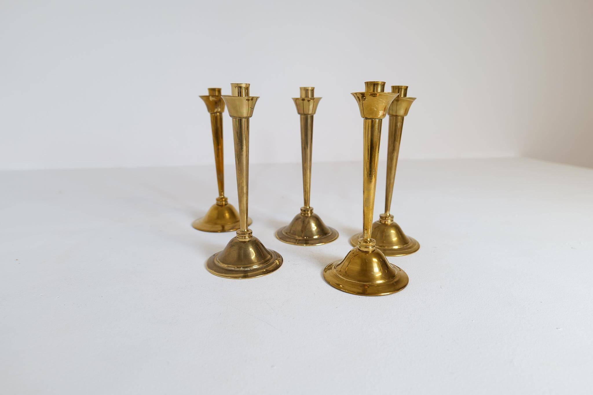 Mid-century set of 5 brass candlesticks by Lars Holmström, Arvika, Sweden.