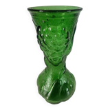 Green glass vase decorated with bunch of grapes and fruits