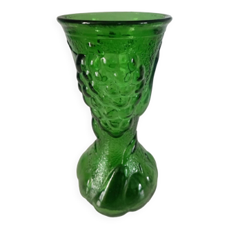 Green glass vase decorated with bunch of grapes and fruits