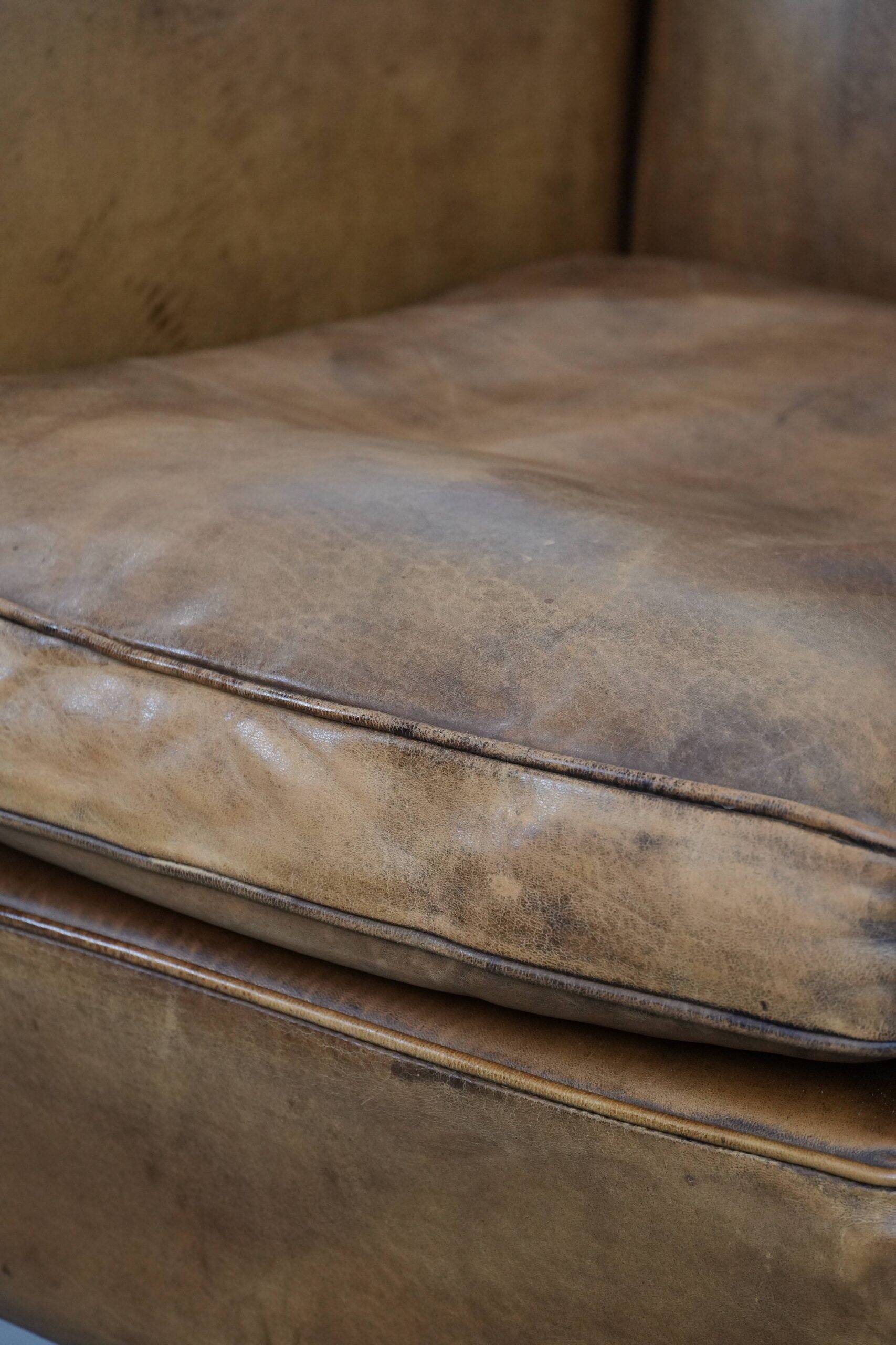 Vintage sheepskin armchair with a beautiful light colour and elegant legs