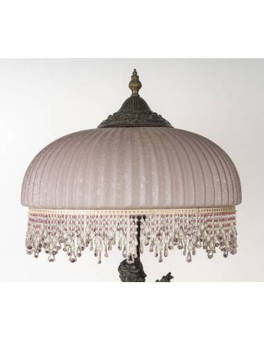 Art Nouveau style lamp with bronze sculpture and glass shade