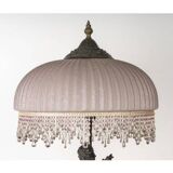 Art Nouveau style lamp with bronze sculpture and glass shade