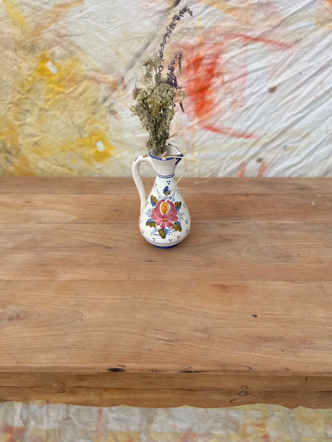 Curved farmhouse table in rustic wood, Provençal style.