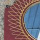 Vintage 1950s sun mirror in gold metal.