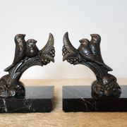 Pair of Art Deco bookends signed Frécourt, patinated metal & black marble