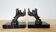 Art Deco bookends signed Frécourt, patinated metal & black marble