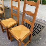 8 wooden dining chairs with straw seats, farmhouse style, high back.