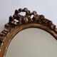 Louis xvi style oval mirror decorated with ribbons