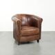 Sheepskin clubarmchair with beautiful patina finished with decorative nails