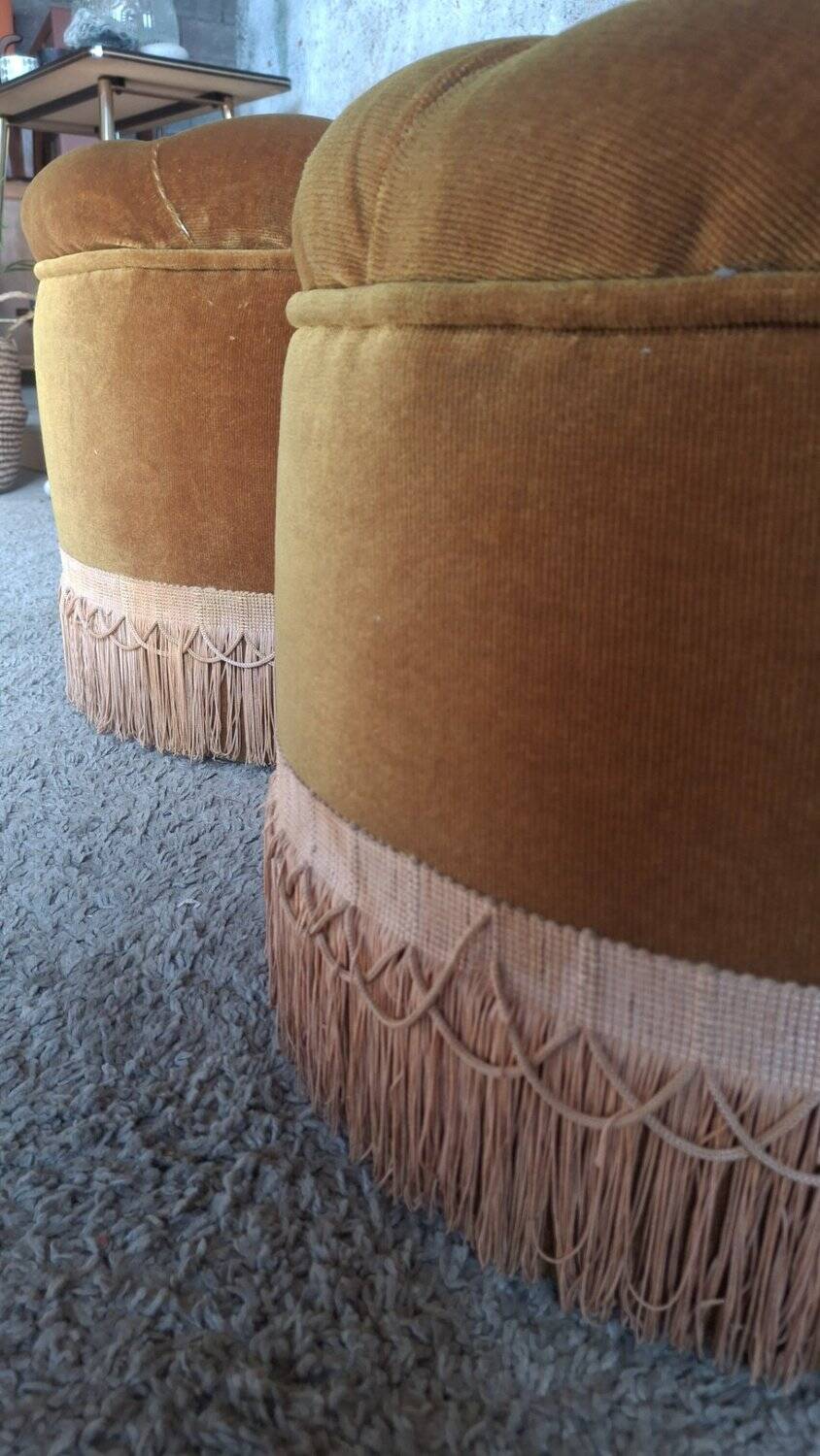 False pair of round Napoleon III poufs in ochre velvet, tufted with fringes.