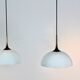 Paire de suspensions en laiton et verre opale blanc par Florian Schulz