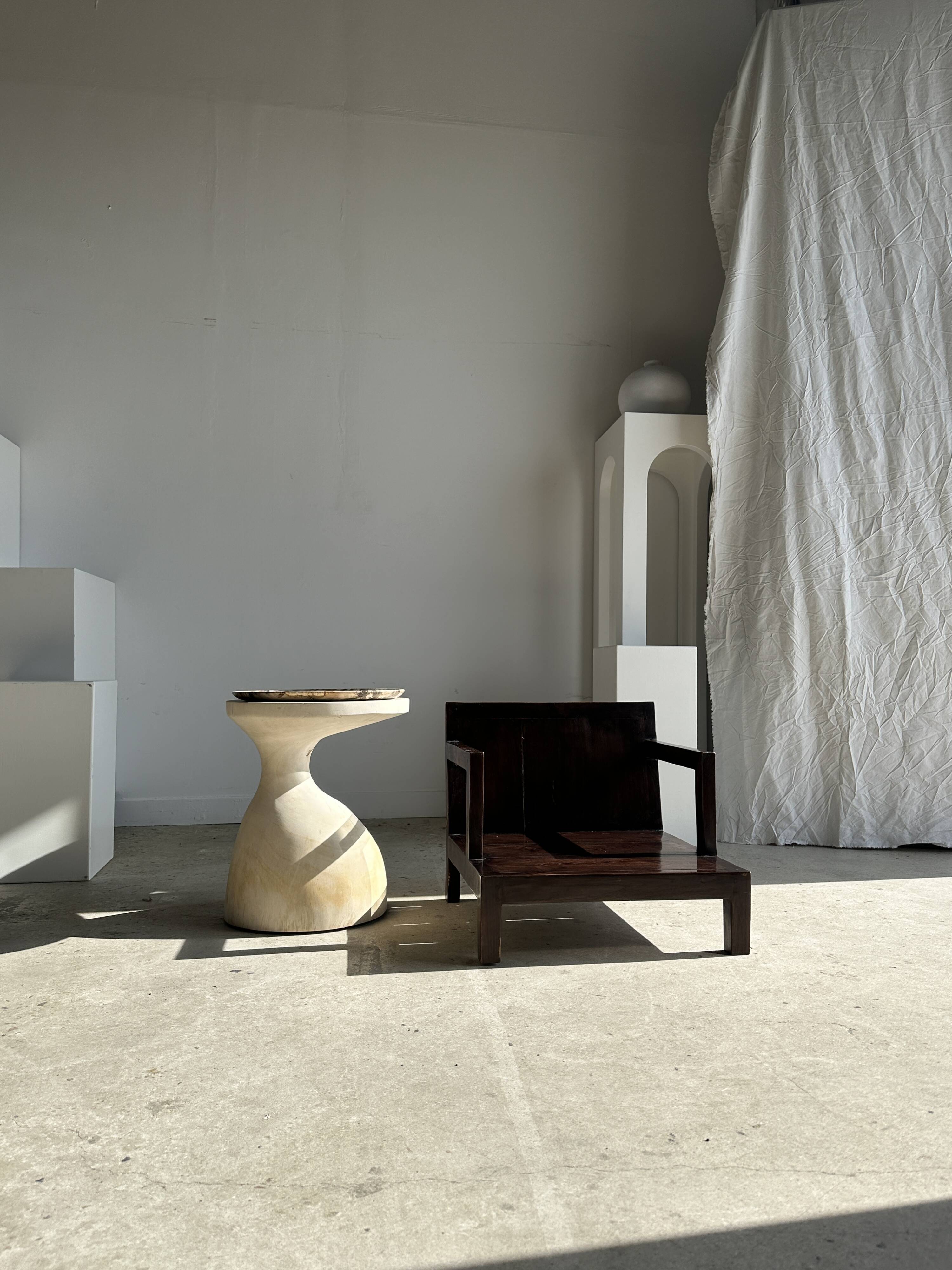 Small low armchair in varnished brown wood