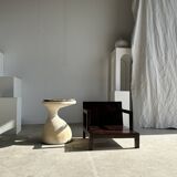 Small low armchair in varnished brown wood