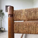 Brutalist style bed with chain and straw