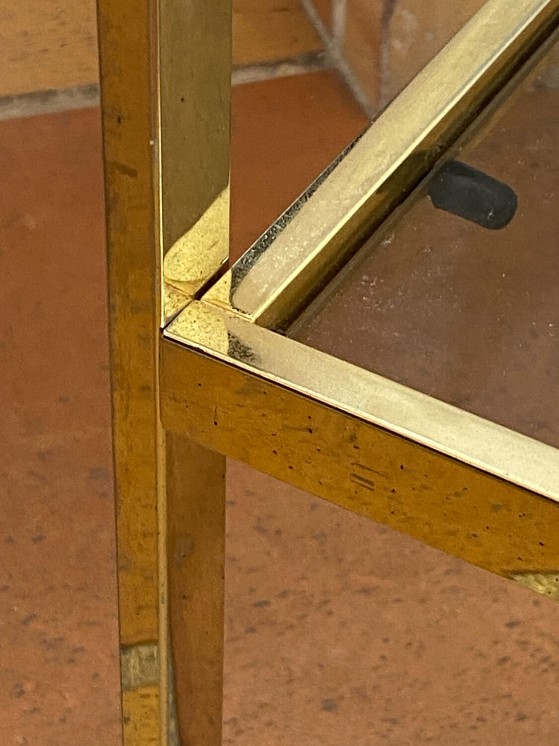 Gold metal and smoked glass console table.