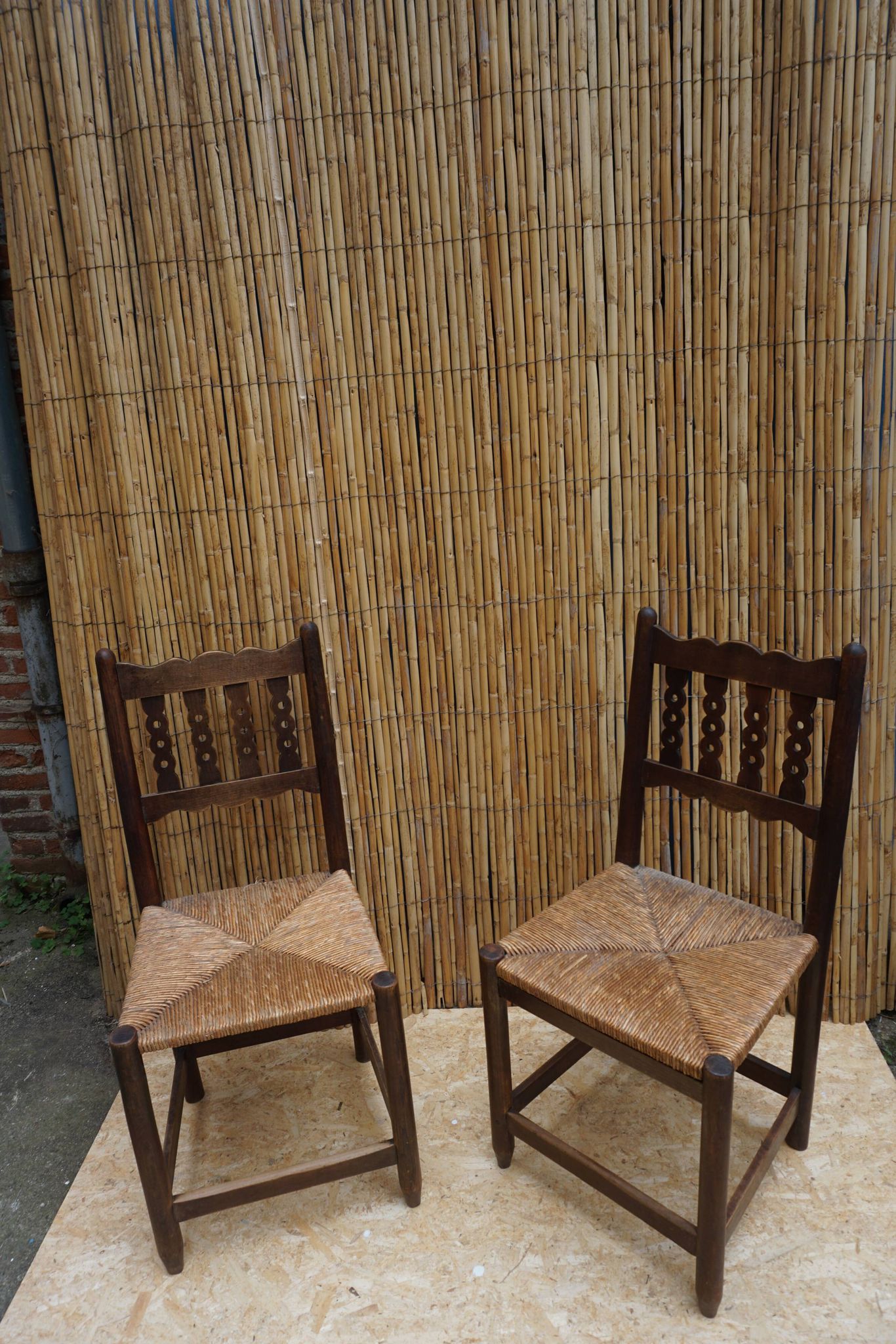 Pair of antique straw-seated farm chairs