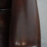 Comfortable wingback chair in English style made of cowhide leather