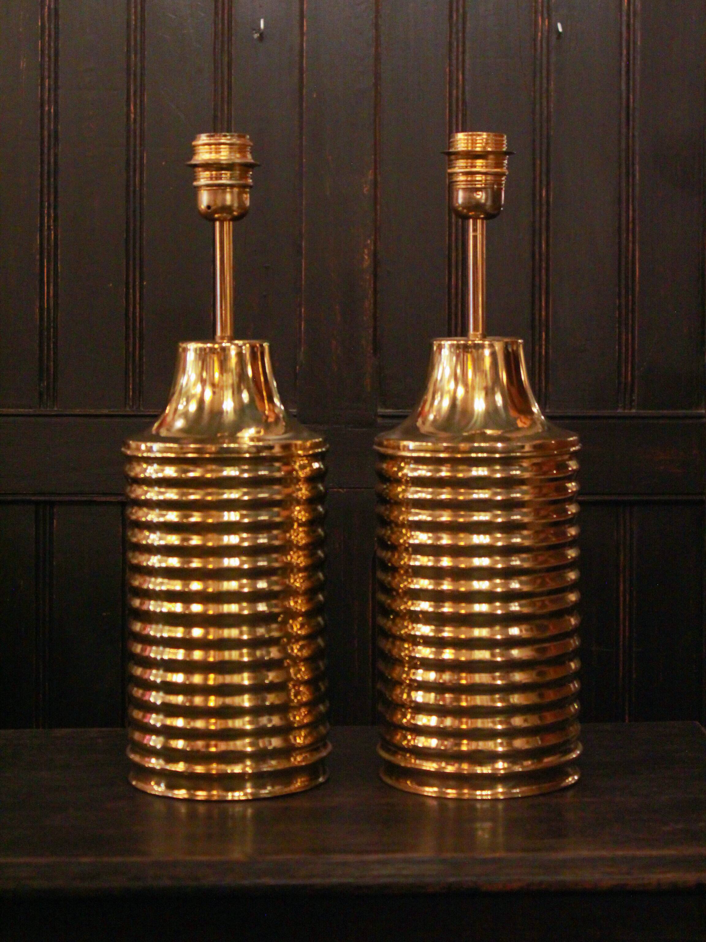 Pair of lamps in gilded brass