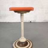 Old swivel orange sitting dentist stool