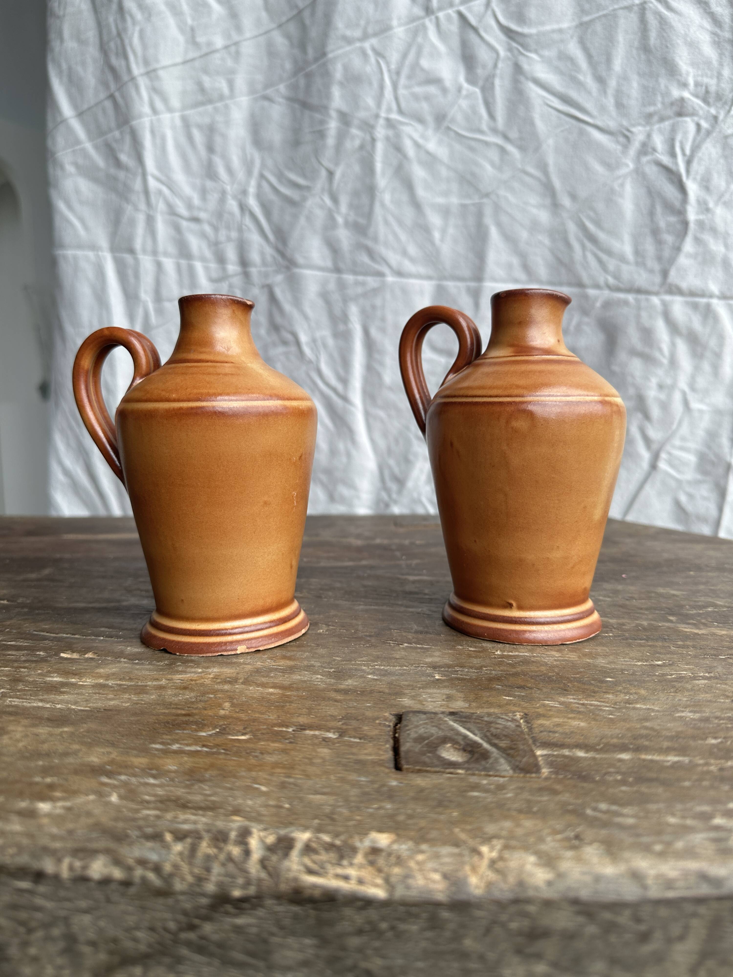 Pair of mini orange stoneware pitchers