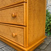 Dresser and its bedside table in rattan caning and vintage oak from the 1970s.