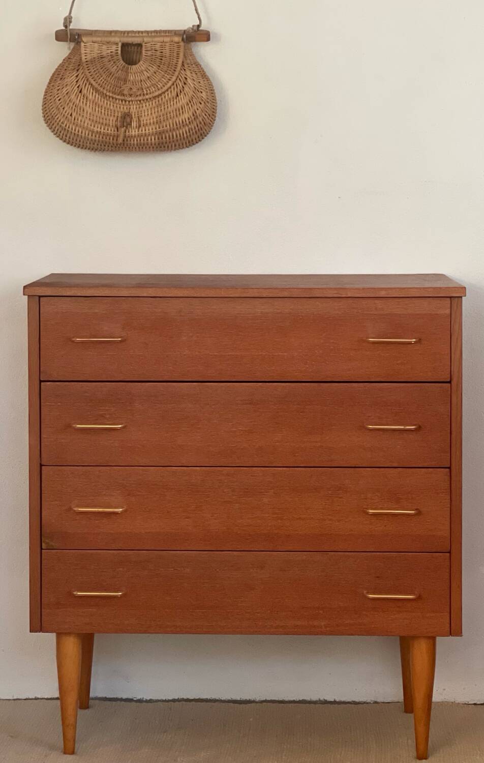 Vintage 1960s chest of drawers with covered handles.