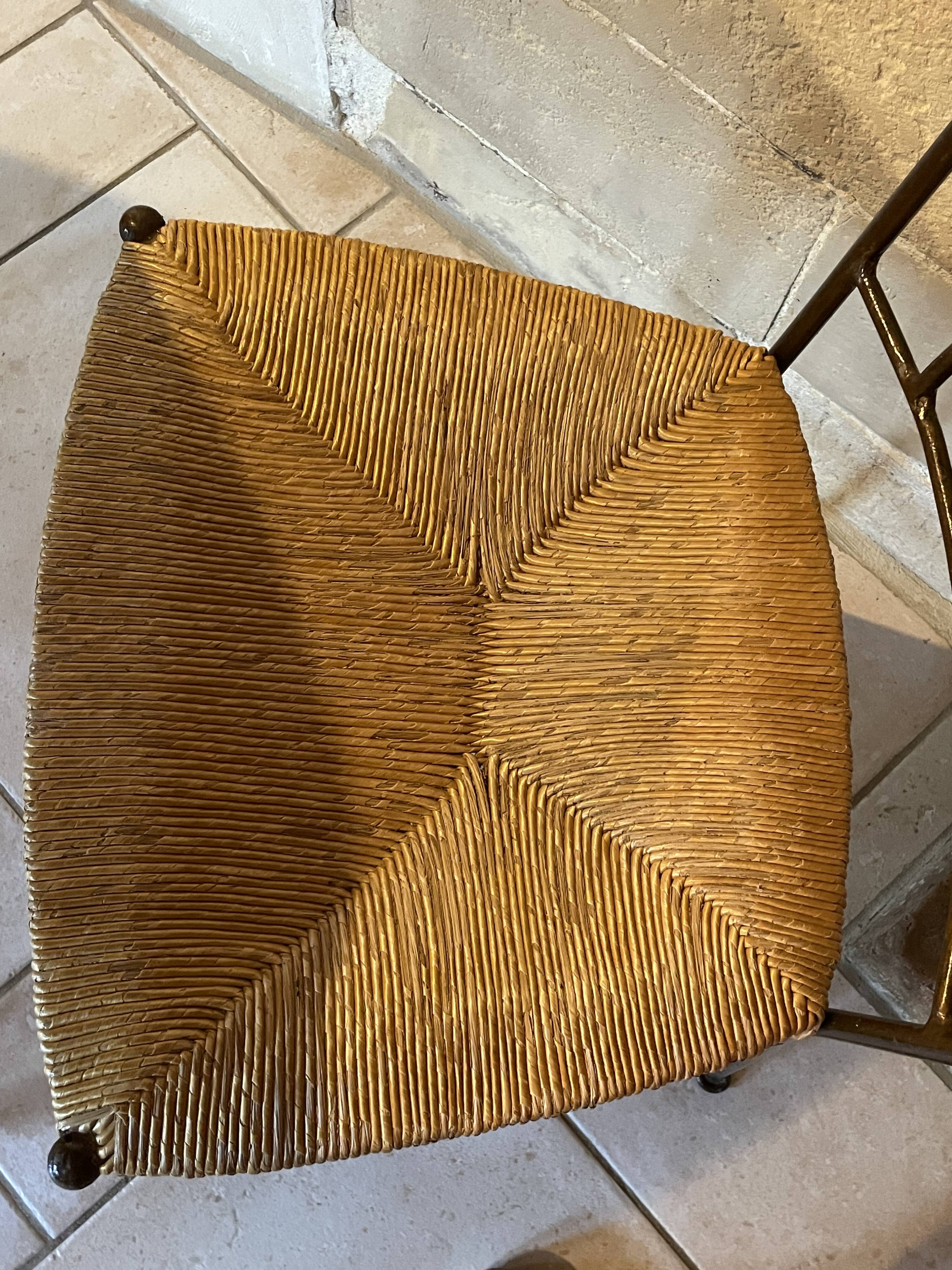 Table and four wrought iron and wood chairs.