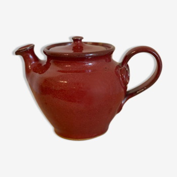 Red teapot in handmade vintage sandstone