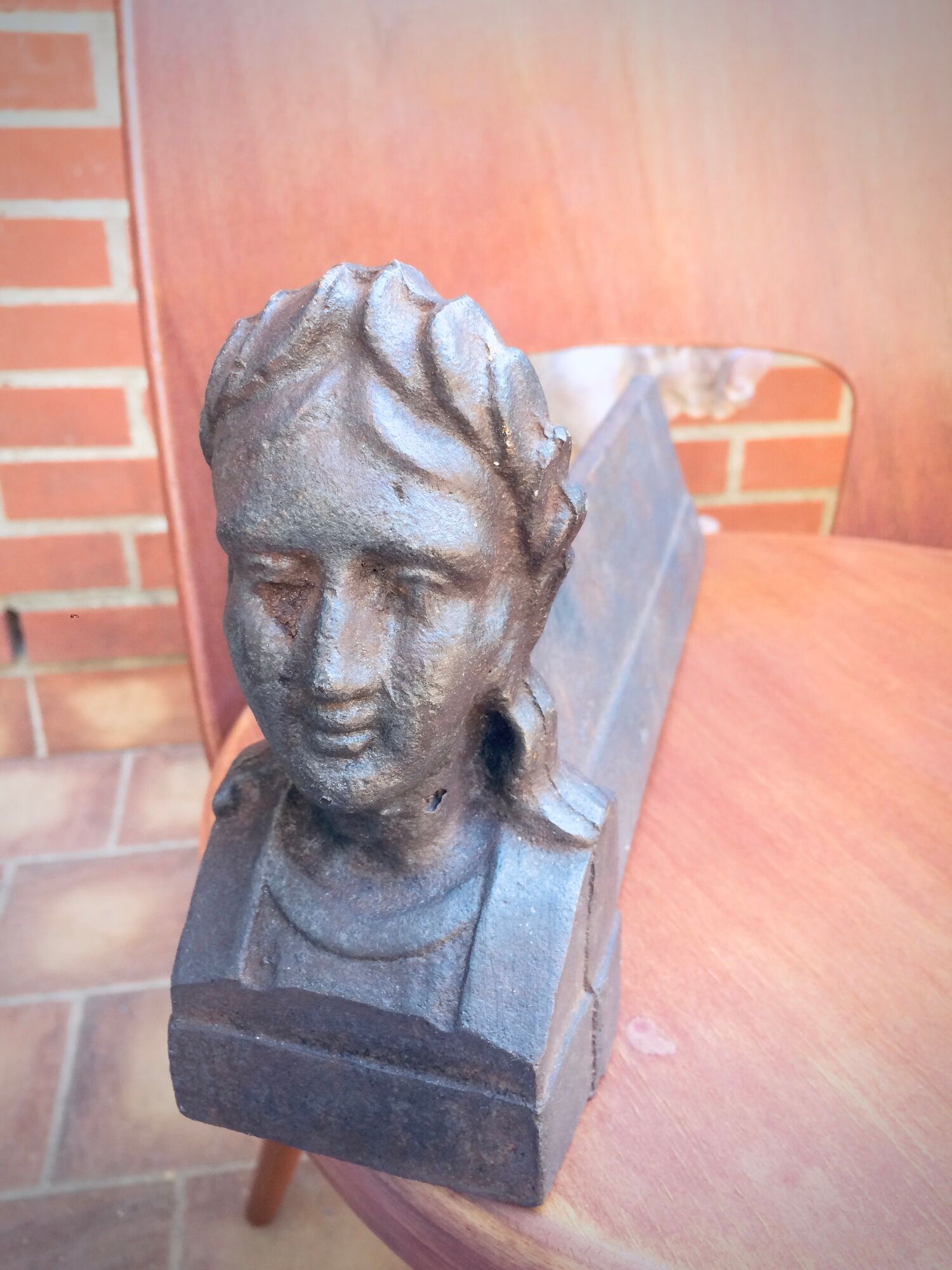 Pair of cast-iron chenet characters with laurels