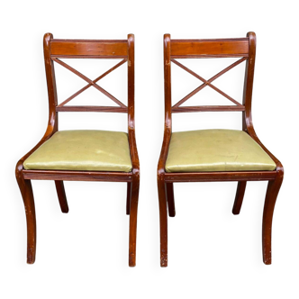2 solid wood and light green leather chairs