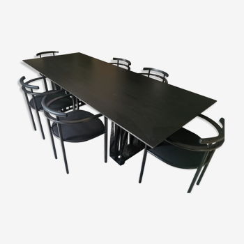 Black dining room table, wooden, rectangle with upholstered chairs.