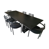 Black dining room table, wooden, rectangle with upholstered chairs.