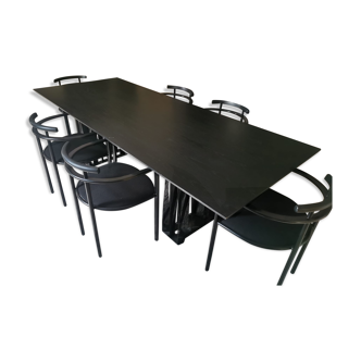 Black dining room table, wooden, rectangle with upholstered chairs.