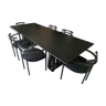 Black dining room table, wooden, rectangle with upholstered chairs.